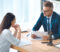 high angle view of lawyer and client looking at each other while discussing contract in office