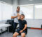 Physical therapist adjusting and massaging his male client's arm in his office.