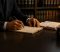 what-happens-after-car-accident-california-blog-2 Lawyer signs papers at a desk with law books in the background.