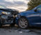 car-accident Two cars collide head-on, with severely damaged fronts and debris on the road at an outdoor scene.